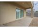 View of the covered patio featuring a sliding glass door and rock landscaping at 10705 E Sunflower Ct, Florence, AZ 85132