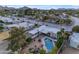 Aerial view of a backyard with a pool, hot tub, lounge chairs, covered patio, and lush landscaping at 11041 N 44Th St, Phoenix, AZ 85028