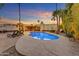 Backyard pool with desert landscaping and hot tub at sunset at 11041 N 44Th St, Phoenix, AZ 85028