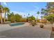 Beautiful backyard featuring a pool, patio, palm trees, and lush landscaping, perfect for outdoor living at 11041 N 44Th St, Phoenix, AZ 85028