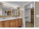 Bathroom with double vanity and a walk-in closet at 11041 N 44Th St, Phoenix, AZ 85028