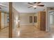 Bedroom featuring neutral walls, hardwood floors, mirrored closet, and a lighted ceiling fan at 11041 N 44Th St, Phoenix, AZ 85028