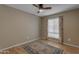 Bedroom featuring neutral walls, hardwood floors, a window with curtains, and a ceiling fan at 11041 N 44Th St, Phoenix, AZ 85028