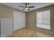 Cozy bedroom with wood floors, ceiling fan, and closet space, illuminated by natural light at 11041 N 44Th St, Phoenix, AZ 85028