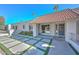 Inviting home entrance with tile roof, stone walkway with inlaid grass accents, and a freshly painted exterior at 11041 N 44Th St, Phoenix, AZ 85028