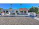 Charming single-story home featuring a red tile roof, decorative rock landscaping, and a secure gated front entrance at 11041 N 44Th St, Phoenix, AZ 85028