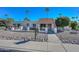 Attractive single-story home with a red tile roof, gated entrance and desert landscaping with palm trees at 11041 N 44Th St, Phoenix, AZ 85028