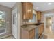 Kitchen with wood cabinets, stainless steel dishwasher, and window over the sink providing natural light at 11041 N 44Th St, Phoenix, AZ 85028