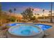 Backyard pool with a hot tub and desert landscaping at sunset at 11041 N 44Th St, Phoenix, AZ 85028