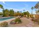 Inviting backyard featuring a sparkling pool, hot tub, lounge chairs and lush desert landscaping at 11041 N 44Th St, Phoenix, AZ 85028