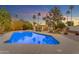 Desert landscaped backyard featuring a clear blue pool and mature trees at 11041 N 44Th St, Phoenix, AZ 85028