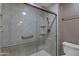 Updated shower with marble surround, grab bars, and overhead shower fixture at 11041 N 44Th St, Phoenix, AZ 85028