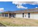 Rear exterior view of home, with enclosed patio and large backyard at 11139 W Cameo Dr, Sun City, AZ 85351