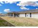 Back exterior of home showing the enclosed patio and yard with palm trees at 11139 W Cameo Dr, Sun City, AZ 85351