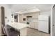 Bright kitchen featuring white appliances, ample cabinetry, and a breakfast bar at 11139 W Cameo Dr, Sun City, AZ 85351