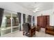 Bright living room with tiled floors, ceiling fan, and sliding door access to patio at 11139 W Cameo Dr, Sun City, AZ 85351