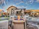 Inviting backyard with a fire pit, seating area, and a well-appointed outdoor kitchen at 11256 S Hopi Dr, Goodyear, AZ 85338