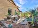 Landscaped backyard featuring a stone pathway, hot tub, and various potted plants at 11256 S Hopi Dr, Goodyear, AZ 85338