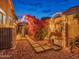 Charming backyard featuring a cozy patio with decorative lights and vibrant bougainvillea at 11256 S Hopi Dr, Goodyear, AZ 85338