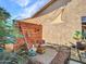 Cozy backyard patio featuring a shaded lounge area, lush plants, and modern design elements at 11256 S Hopi Dr, Goodyear, AZ 85338