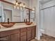 Bathroom featuring dual vessel sinks, decorative lighting and white shower curtain and tiled flooring at 11256 S Hopi Dr, Goodyear, AZ 85338