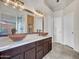 Bathroom featuring double sinks, modern lighting, and a glass shower at 11256 S Hopi Dr, Goodyear, AZ 85338