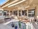 Covered patio with dining table, chairs, ceiling fan and views of the lovely backyard at 11256 S Hopi Dr, Goodyear, AZ 85338