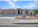 Single story home featuring low maintenance desert landscaping with a three car garage in a residential neighborhood at 11256 S Hopi Dr, Goodyear, AZ 85338