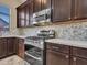 Close-up of the gas range and stainless steel microwave in this kitchen at 11256 S Hopi Dr, Goodyear, AZ 85338