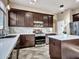 Beautiful kitchen featuring stainless steel appliances, dark wood cabinetry, and white countertops at 11256 S Hopi Dr, Goodyear, AZ 85338