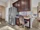 Kitchen area with refrigerator and desk setup, perfect for working from home at 11256 S Hopi Dr, Goodyear, AZ 85338