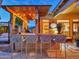 Outdoor bar with seating, perfect for casual dining and entertaining with overhead lighting at 11256 S Hopi Dr, Goodyear, AZ 85338