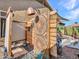 Stylish outdoor shower featuring unique mosaic tiles, a rain shower head, and natural wood accents at 11256 S Hopi Dr, Goodyear, AZ 85338