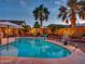 Beautiful backyard pool surrounded by palm trees, creating a private and relaxing oasis at 11256 S Hopi Dr, Goodyear, AZ 85338