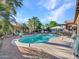 Beautiful swimming pool surrounded by palm trees, lounge chairs, and brick pavers at 11256 S Hopi Dr, Goodyear, AZ 85338