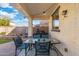 Cozy covered patio featuring patio furniture, decorative lights, and a view of the backyard at 12038 W Briles Rd, Peoria, AZ 85383