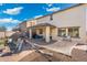 Expansive backyard features a hammock area, outdoor seating, and a covered patio for dining and relaxing at 12038 W Briles Rd, Peoria, AZ 85383