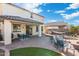 Spacious backyard offers an outdoor dining area, lounging furniture, artificial turf, and a charming hammock setup at 12038 W Briles Rd, Peoria, AZ 85383