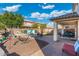 Large backyard with a hammock, covered patio, outdoor dining, and a decorative water feature for relaxing outdoors at 12038 W Briles Rd, Peoria, AZ 85383