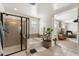 Bright bathroom featuring a soaking tub, walk-in shower, and neutral finishes with open doorway at 12038 W Briles Rd, Peoria, AZ 85383