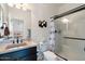 Bathroom featuring a glass shower, stylish shower curtain, sink, mirror, and toilet at 12038 W Briles Rd, Peoria, AZ 85383