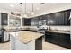 Well-appointed kitchen featuring dark wood cabinets, granite counters, and stainless steel appliances at 12038 W Briles Rd, Peoria, AZ 85383