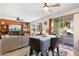 Open-concept living area flowing into dining space, with stylish furnishings and bright natural light at 12038 W Briles Rd, Peoria, AZ 85383