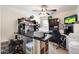 Office featuring neutral walls, carpet, ceiling fan and dark wood shelves, desk and furniture at 12038 W Briles Rd, Peoria, AZ 85383