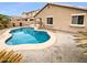 Inviting backyard with a freeform pool and landscaped surroundings, perfect for relaxation at 12163 W Chase Ln, Avondale, AZ 85323