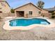 Private backyard featuring a sparkling pool, desert landscaping, and a covered patio at 12163 W Chase Ln, Avondale, AZ 85323