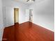 Bedroom with hardwood floors, neutral walls, and a closet with sliding doors at 12163 W Chase Ln, Avondale, AZ 85323