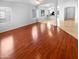 Bright open living room with hardwood floors, neutral paint, ceiling fan, and great natural light at 12163 W Chase Ln, Avondale, AZ 85323