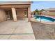 View of the covered patio and freeform pool in a nicely landscaped backyard at 12163 W Chase Ln, Avondale, AZ 85323