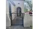 Wrought iron gate that opens to a cozy entrance with desert plants at 12733 W Mine Trl, Peoria, AZ 85383